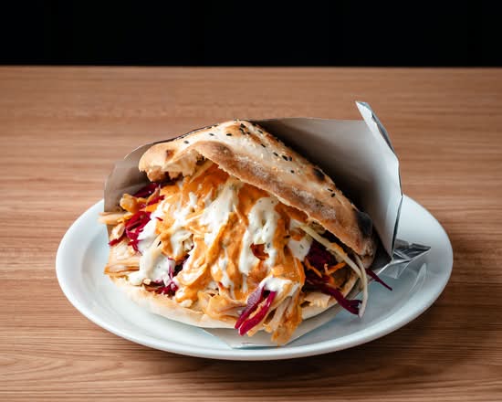 Chicken döner in fresh bread with sauces and slaw