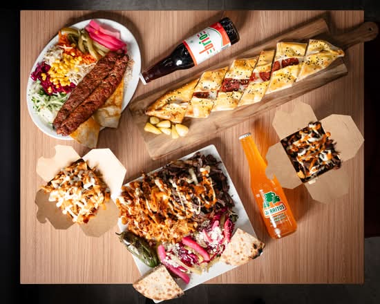 A full Baba Döner spread: kebab, pide, döner boxes and drinks